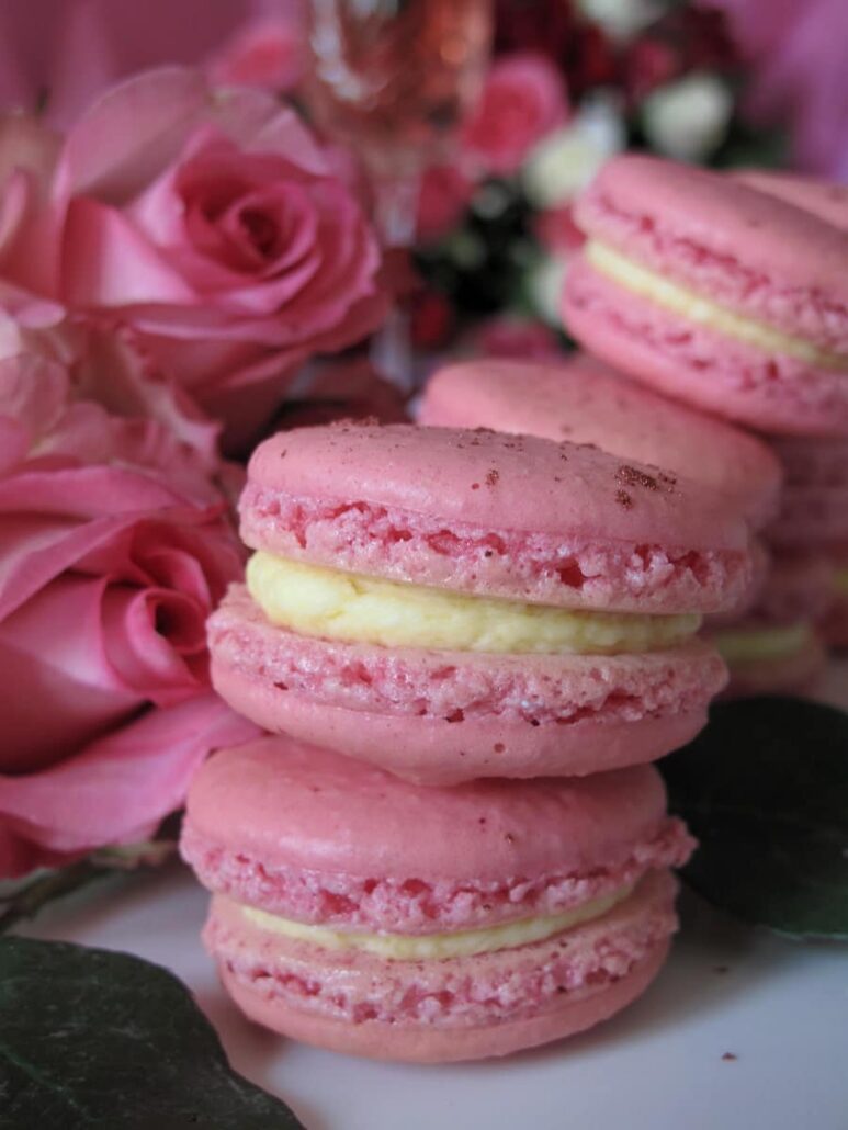 pastel pink rose macarons -  sandwiched cookies surrounded by roses