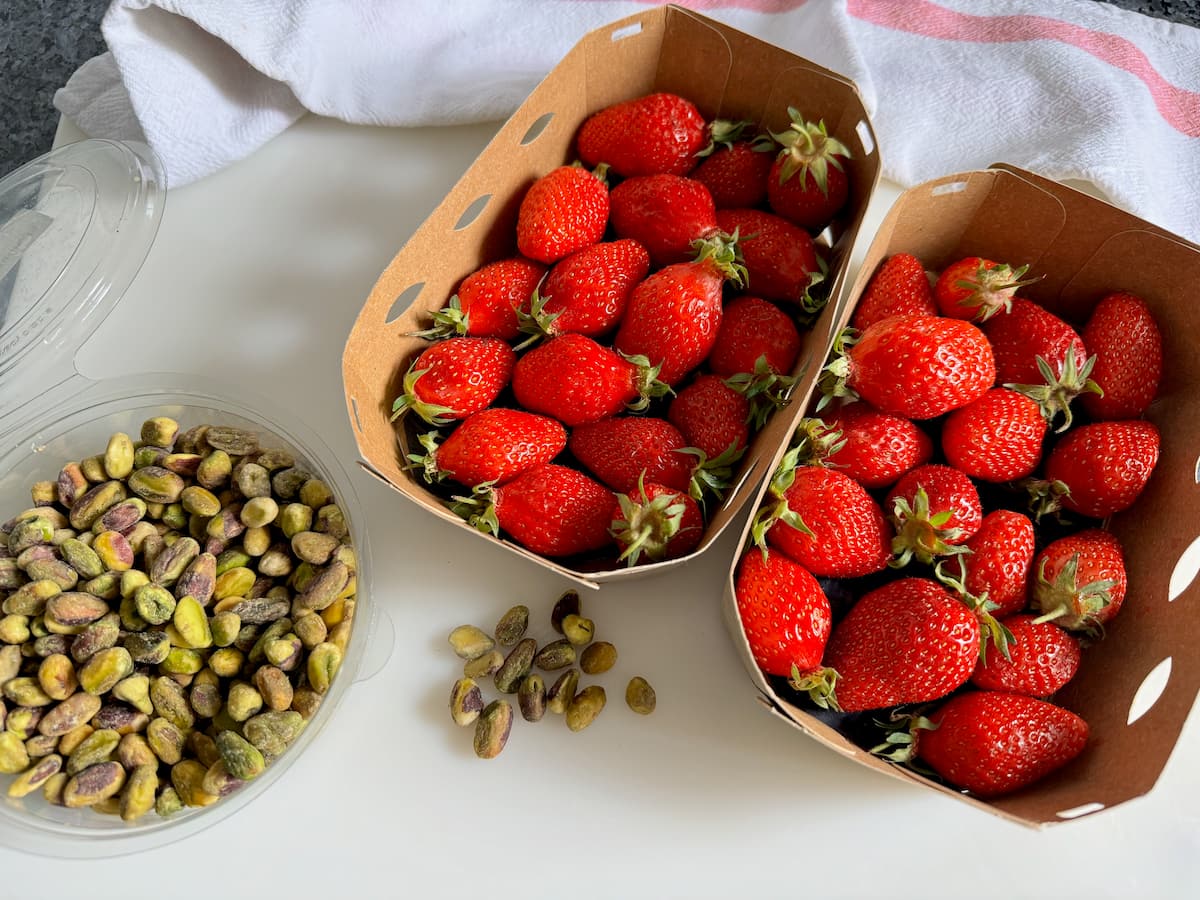 two large boxes of fresh French strawberries and fresh pistachio nuts