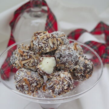 bite-sized fondant macaroons in glass dish one bitten