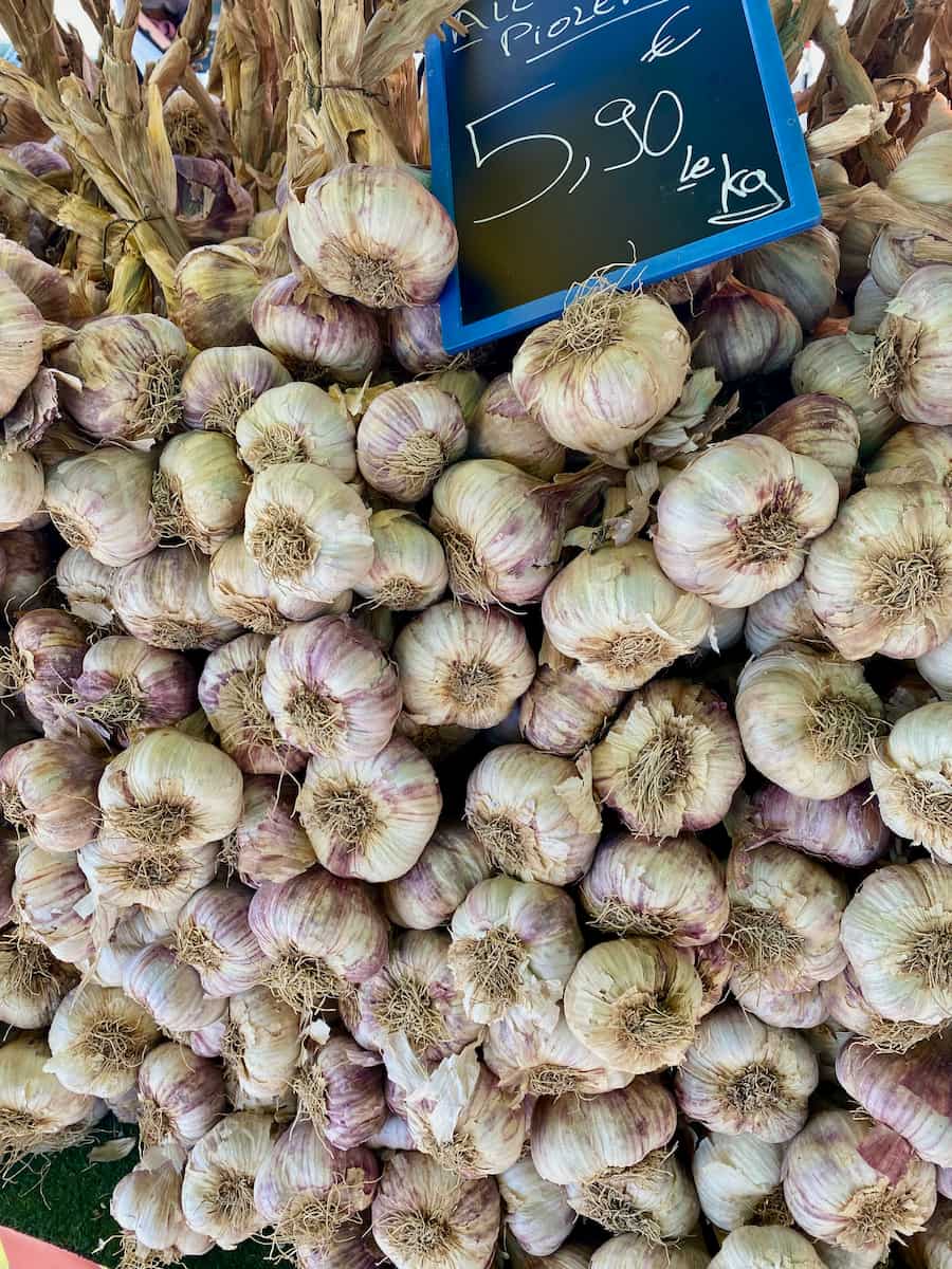 rows of violet garlic at the market in Provence
