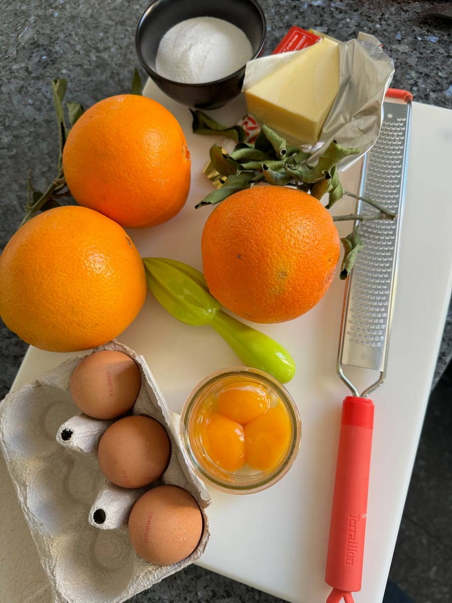 oranges with leaves, fresh eggs, yolks, butter and sugar - curd  ingredients
