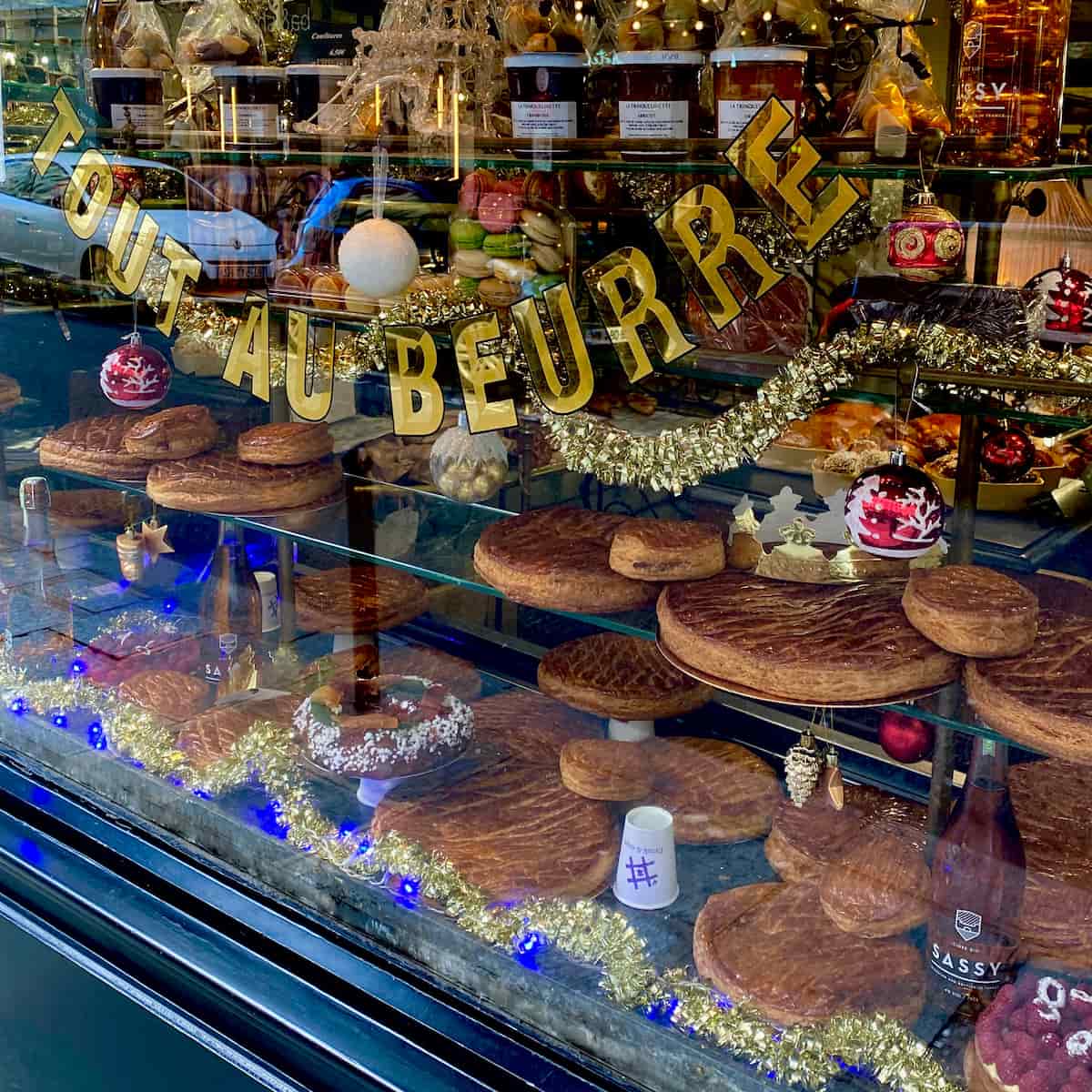 Paris bakery window filled with galettes des rois king cakes