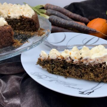 slice of moist, dark cake topped with cream cheese frosting