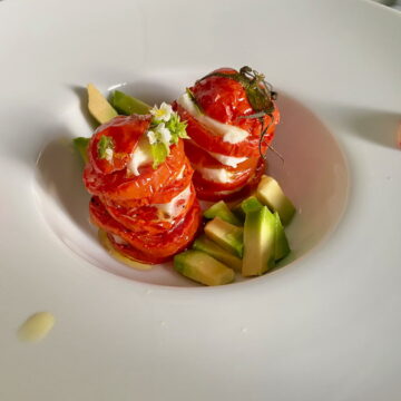 roasted tomatoes and mozzarella in large dish with radishes