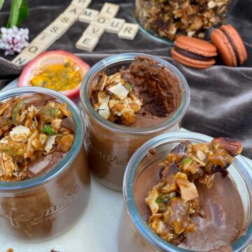 chocolate mousse with passion fruit, topped with caramel nougat macarons in background