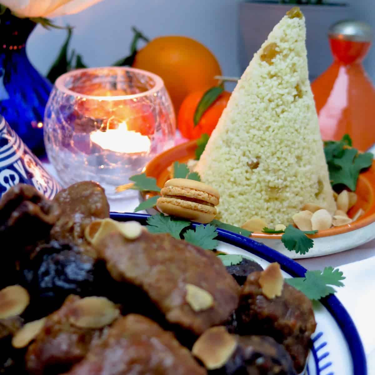 plate of stew and couscous tower with a curry macaron