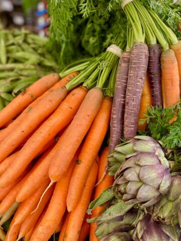 bunch of orange and mixed coloured carrots at the market