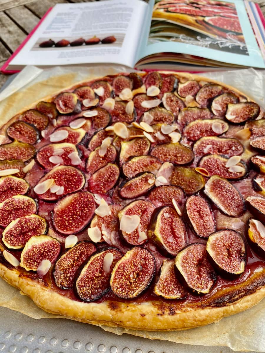 large puff pastry tart topped with sliced fresh figs