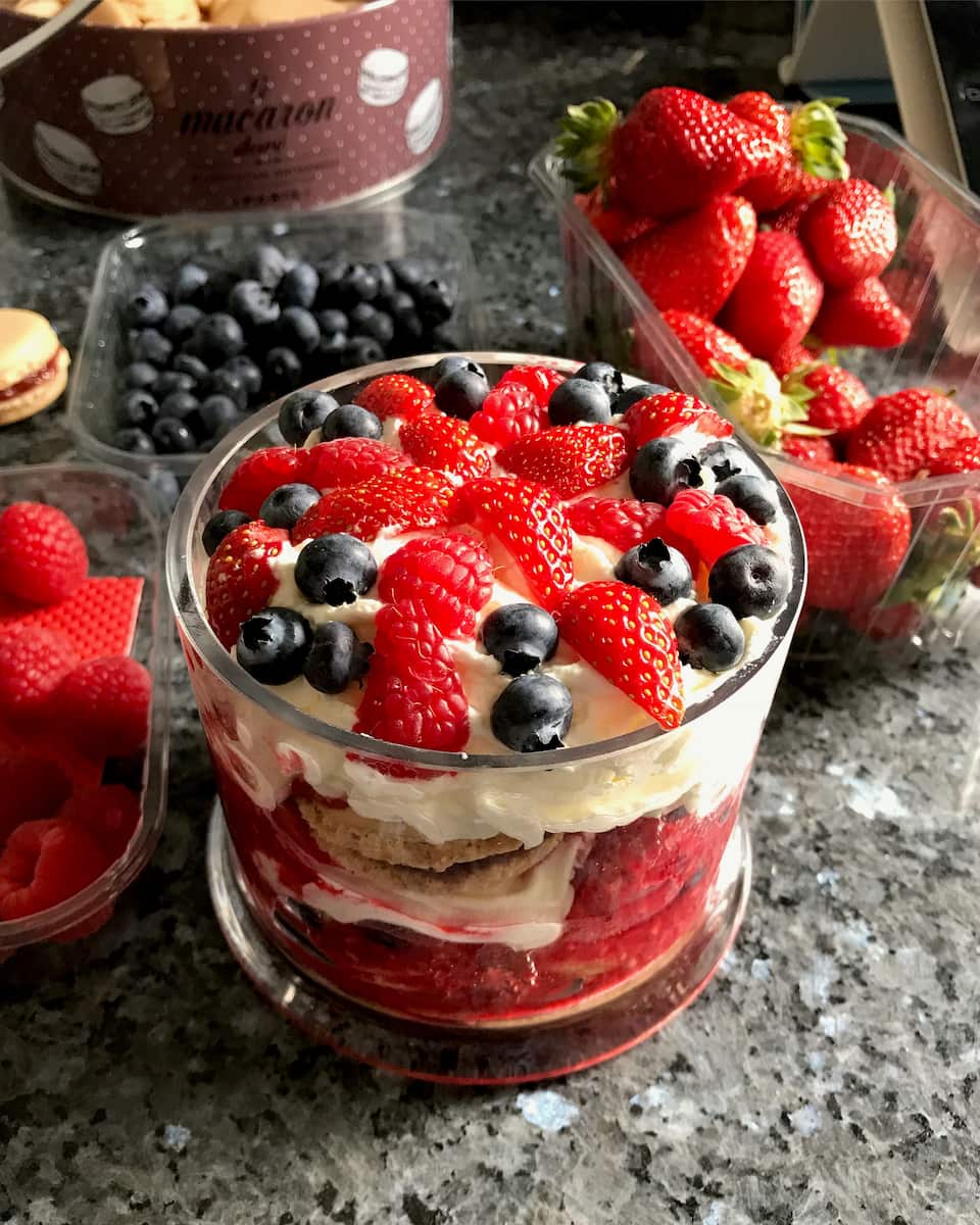 berry trifle for two, topped with strawberries, raspberries and blueberries for a red white and blue dessert