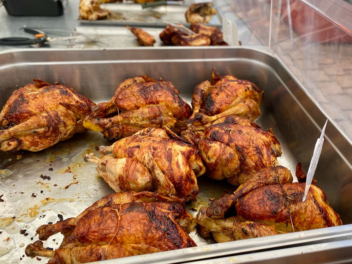 large tray of roasted chickens at a French market