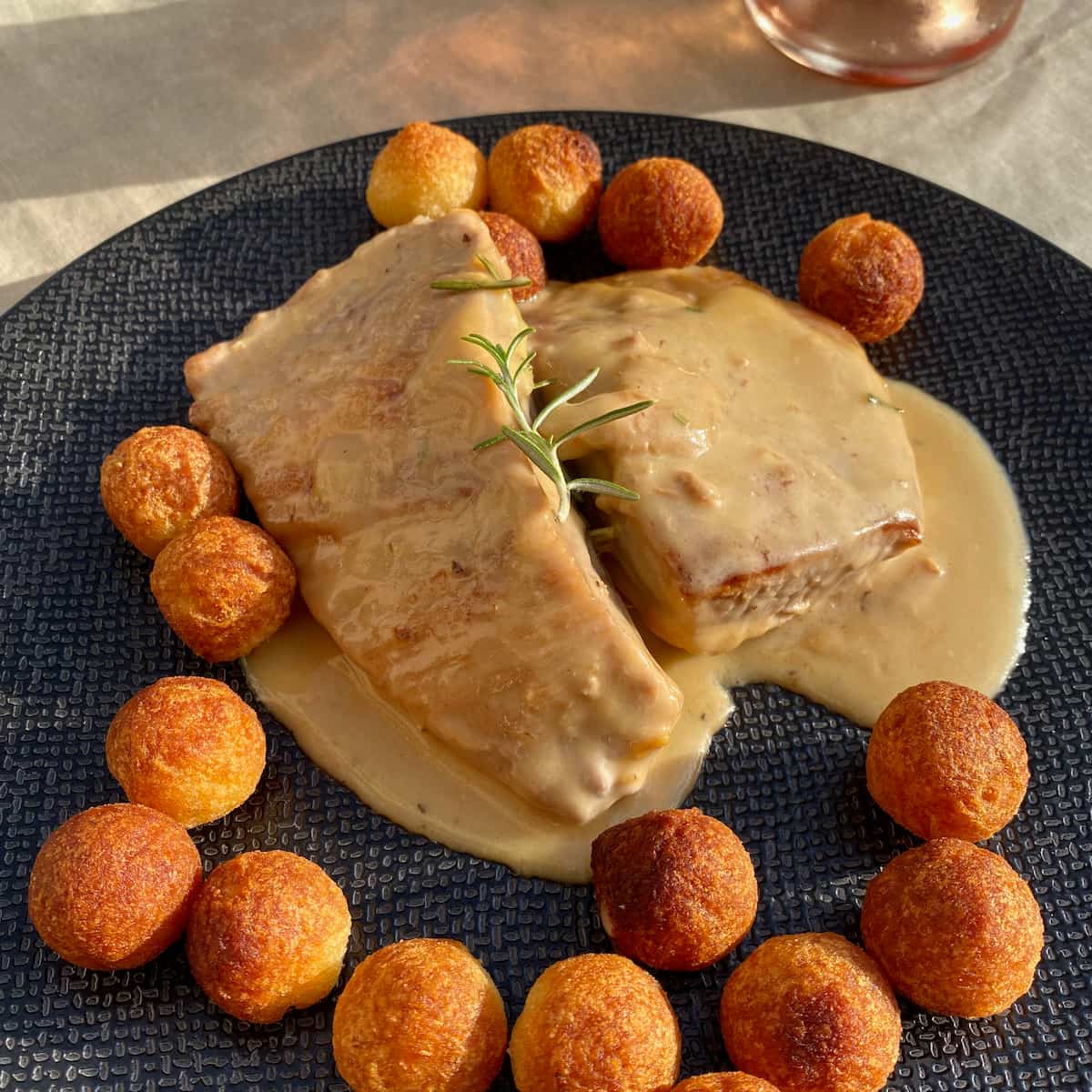 slices of pork in honey sauce with pommes noisette crispy potatoes