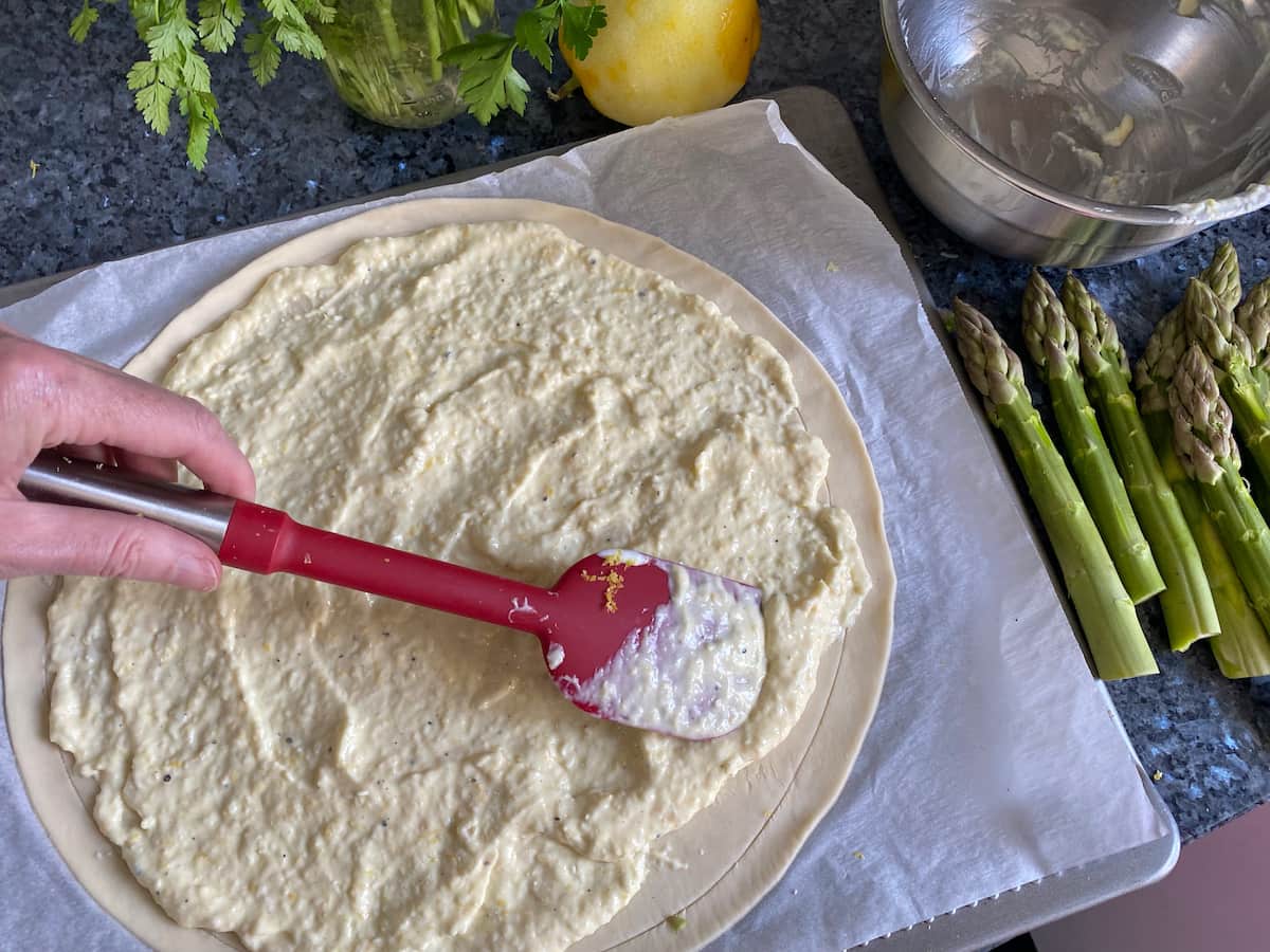 spreading on lemon parmesan cream on puff pastry