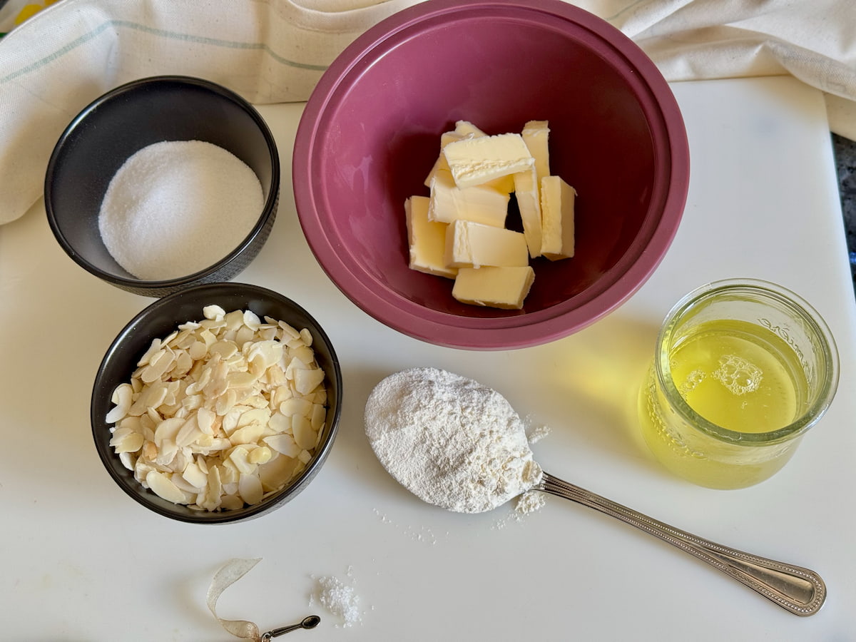 Tuiles ingredients measured out: butter, flaked almonds, egg whites, sugar, flour and salt