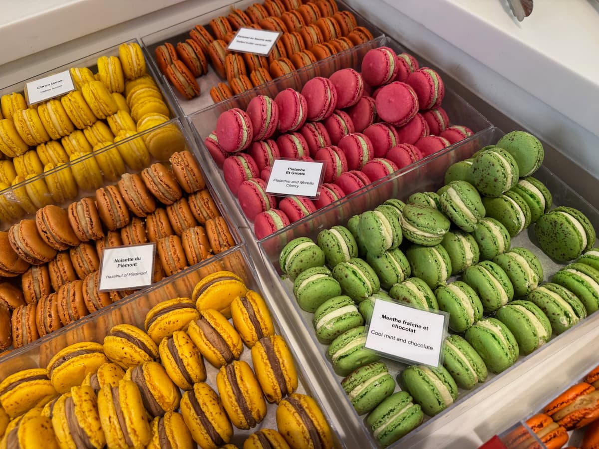 boxes of perfect French macarons at Pain de Sucre Paris showing mint, pistachio and cherry, passion fruit and chocolate
