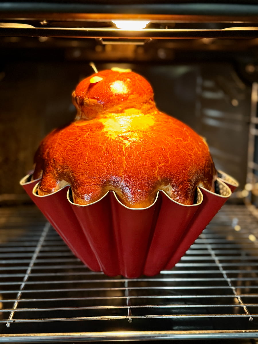 golden brown brioche baking in a fluted tin and rising in the oven