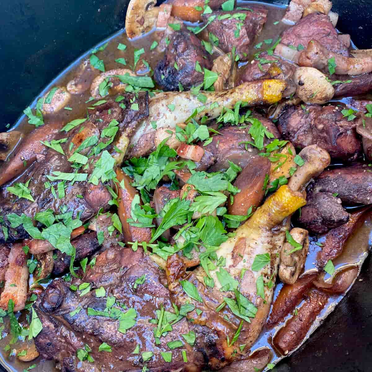 finished dish of coq au vin with freshly chopped parsley