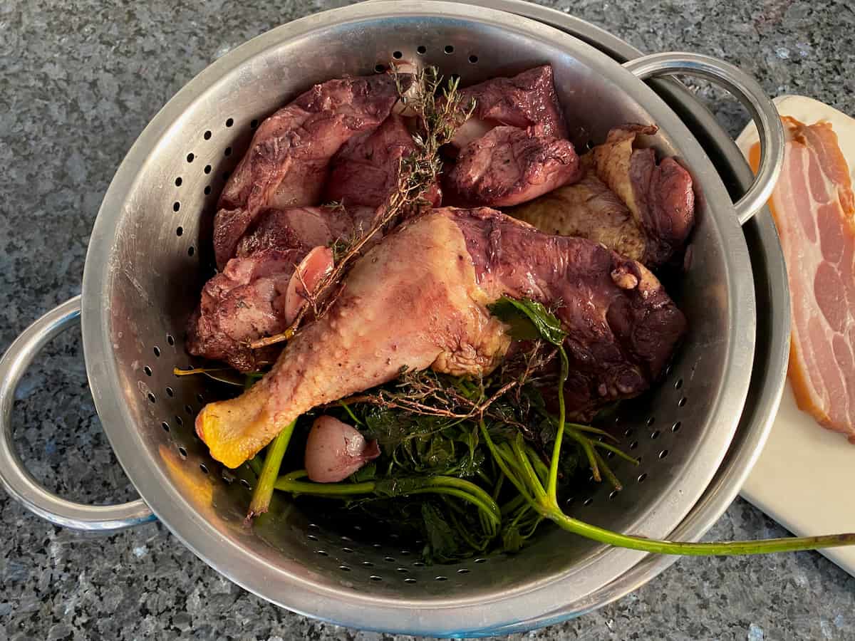 Draining the red wine marinade for chicken