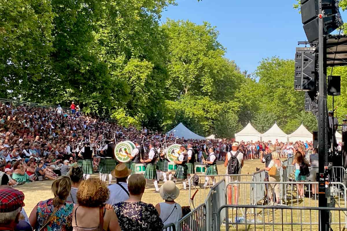 summer crowd watching a pipe band