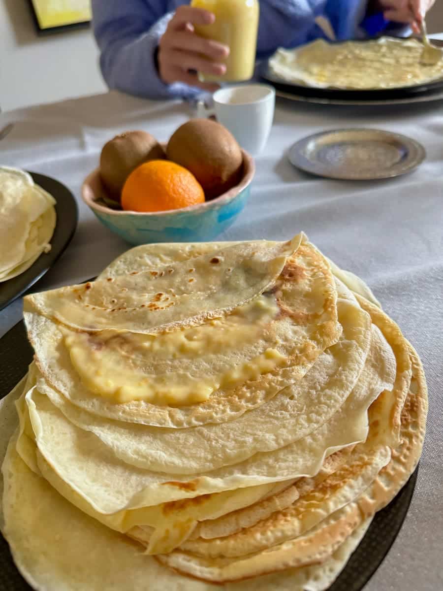 stack of thin homemade French crêpes filled with orange curd
