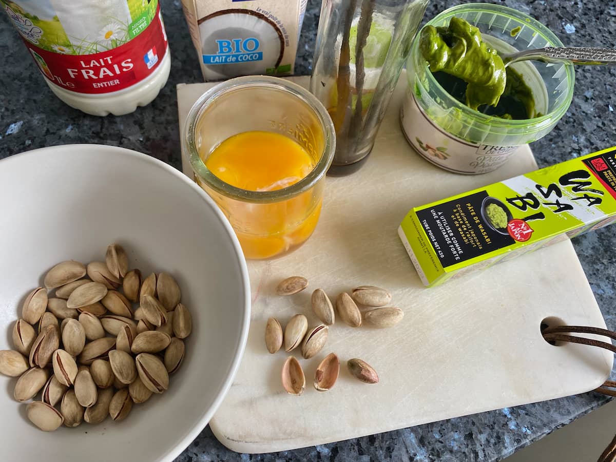 ingredients to make ice cream: egg yolks, pistachios, pistachio paste, milk, coconut milk, vanilla and optional wasabi