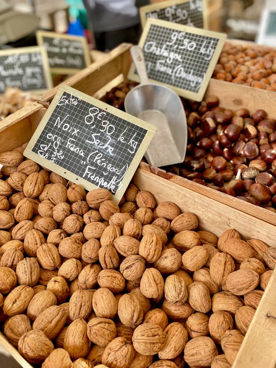 wooden crates of fresh walnuts with a French sign saying Franquette from the Perigord region.