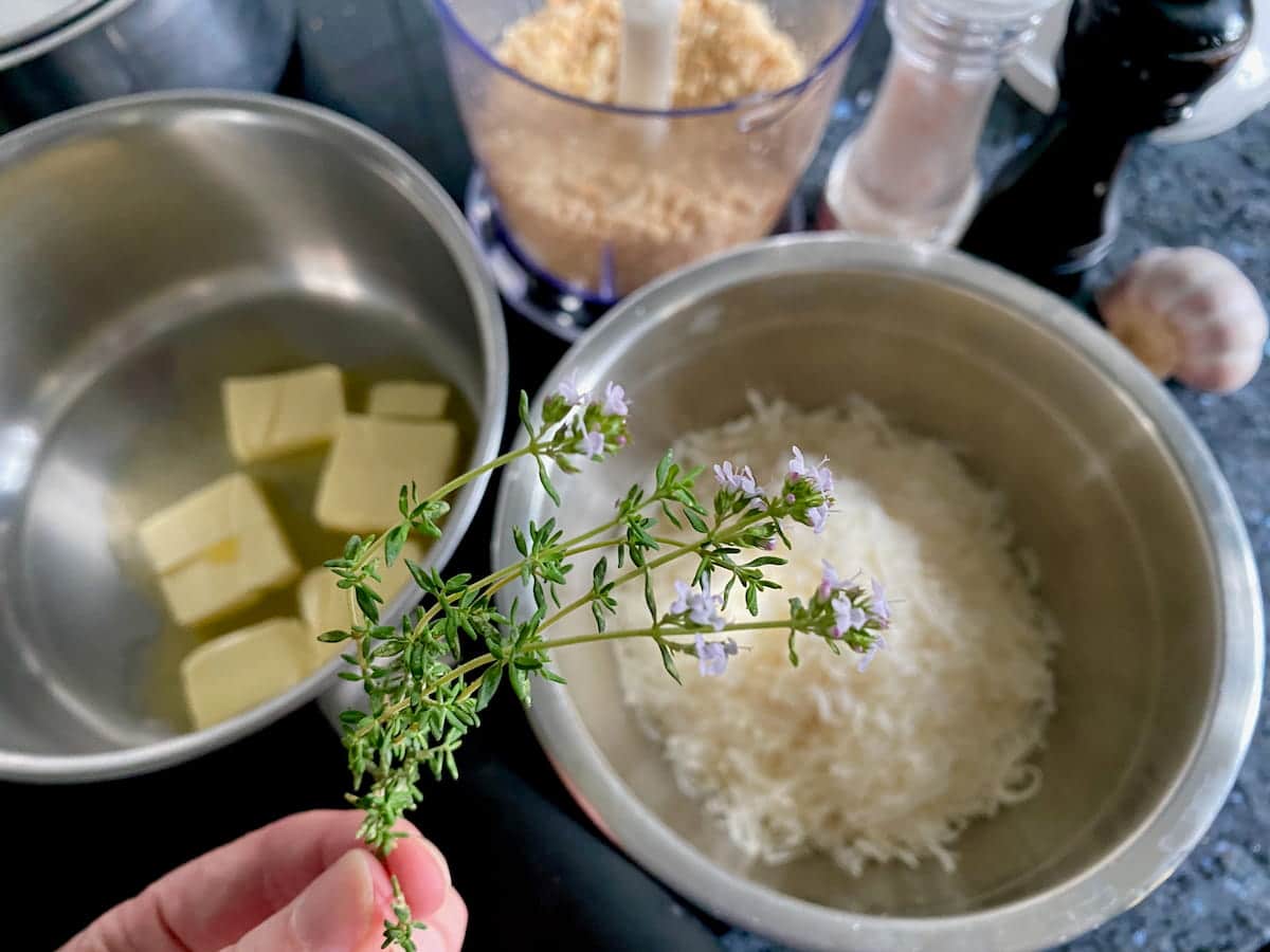 bowl of grated parmesan, pan of melting butter, breadcrumbs and fresh thyme