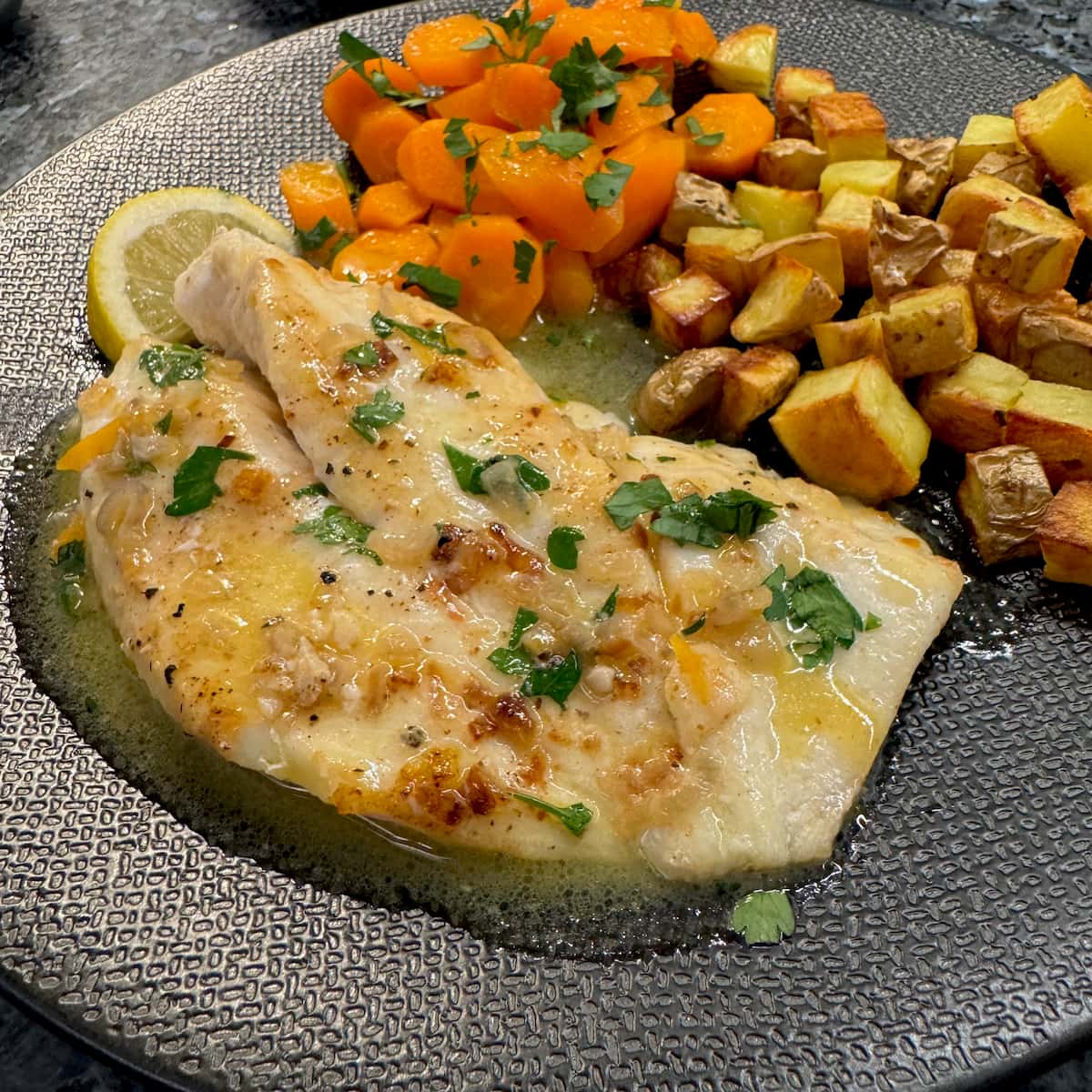 John Dory fish filet served in lemon juice, butter and parsley