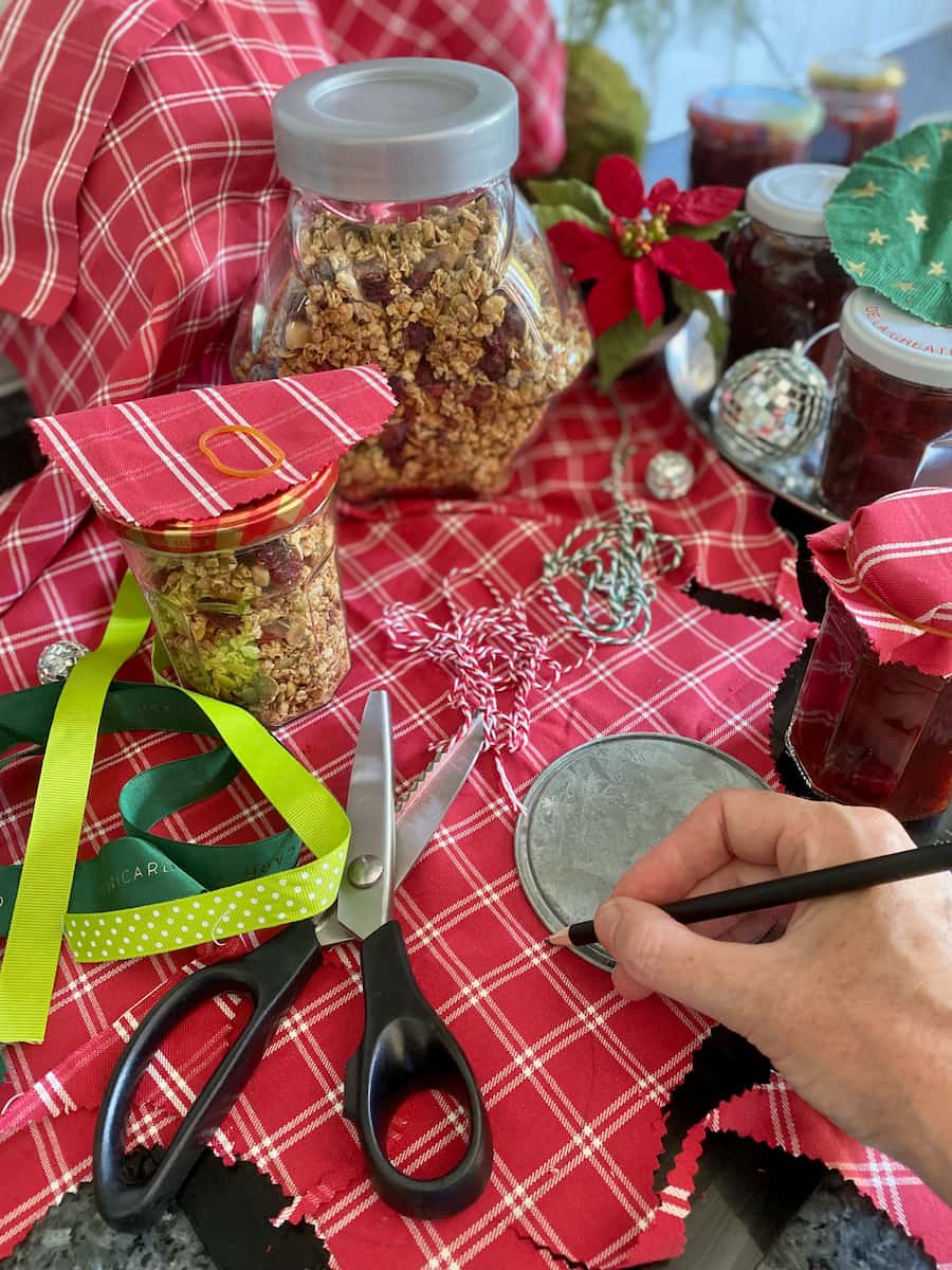 jars of Christmas edible food gifts with serrated scissors to cut pretty festive material for jar tops
