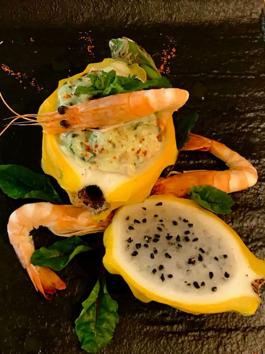 shrimp cocktail presented inside half a dragon fruit