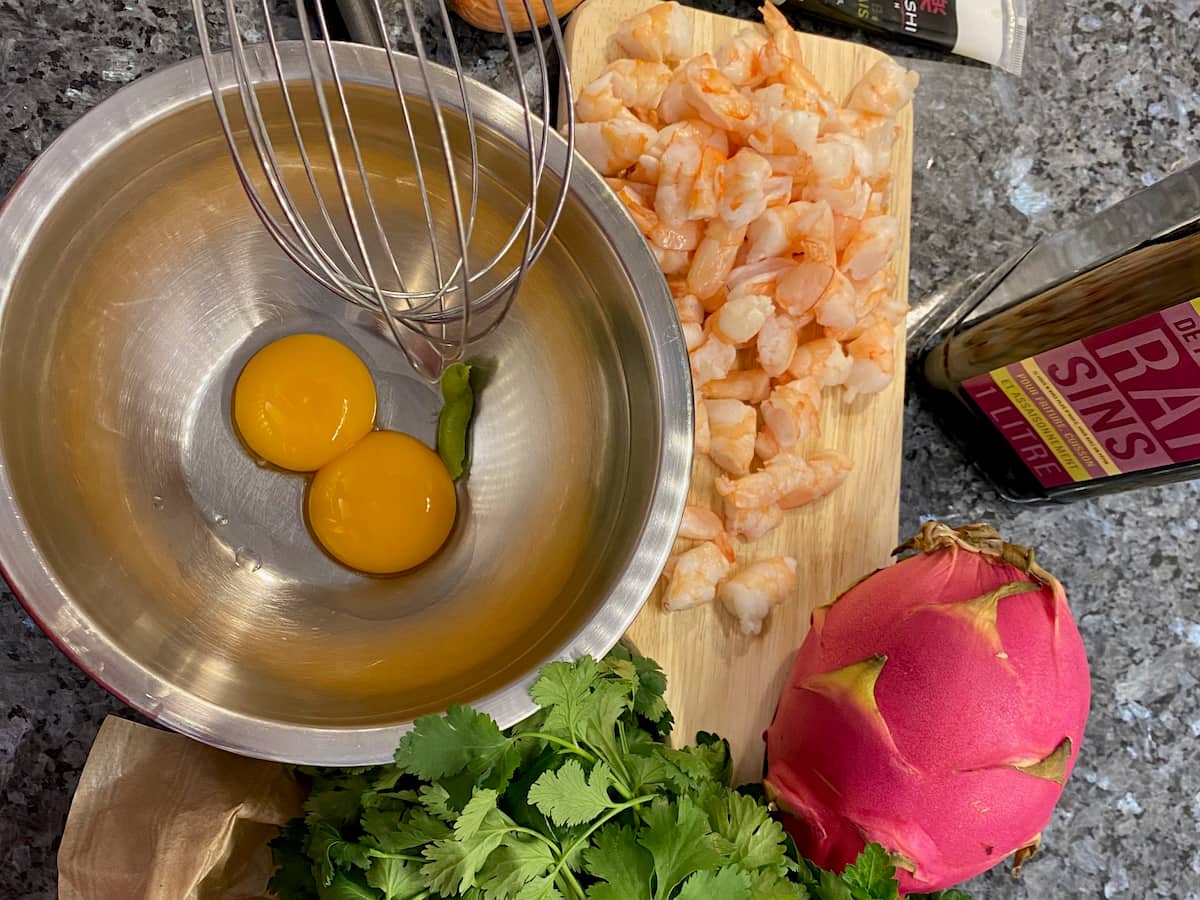2 egg yolks in a bowl with a little wasabi paste