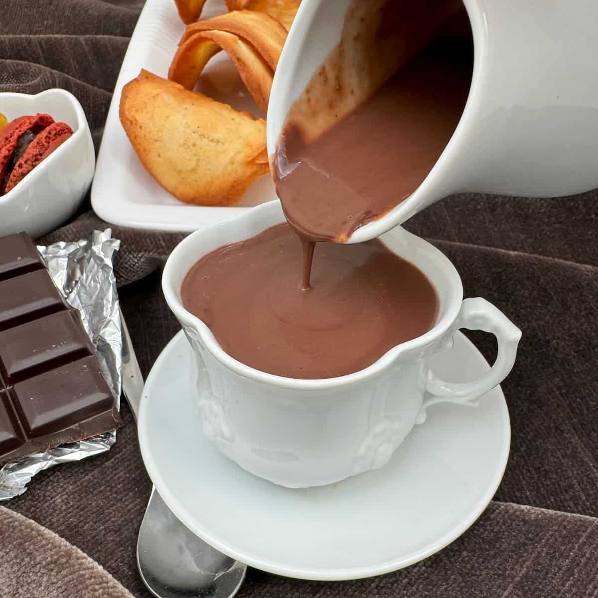 pouring thick homemade hot chocolate from a jug