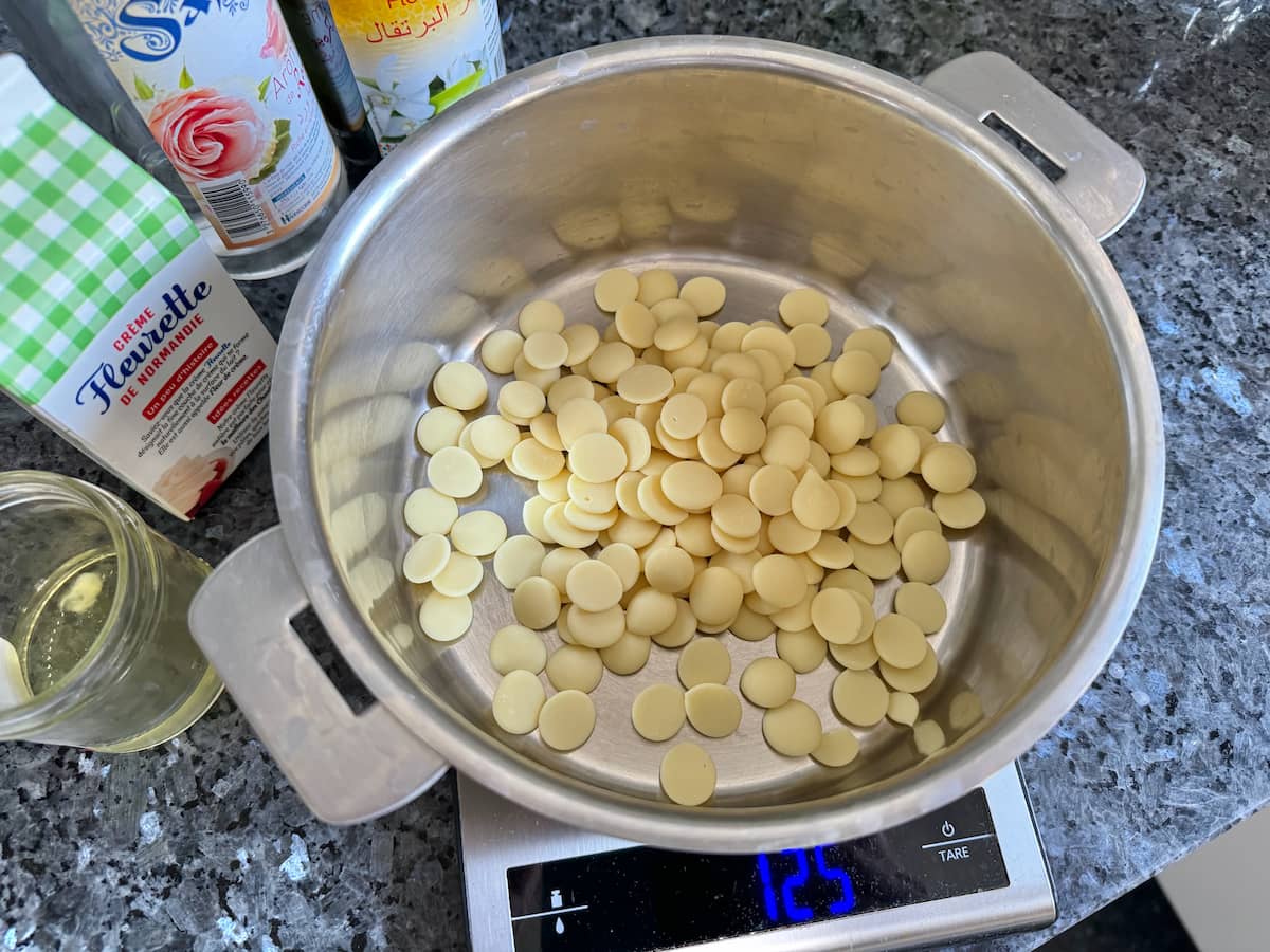 pan of white chocolate drops, heavy whipped cream and an egg white