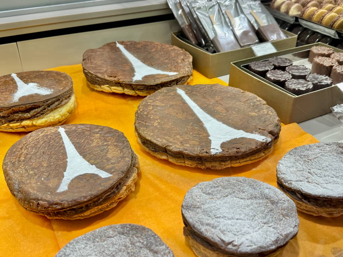 chocolate puff pastry galettes des rois topped with an Eiffel Tower in powdered sugar