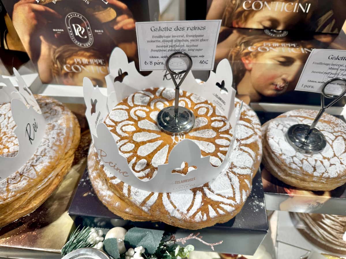 a round puff pastry cake laced with powdered sugar with a crown on top