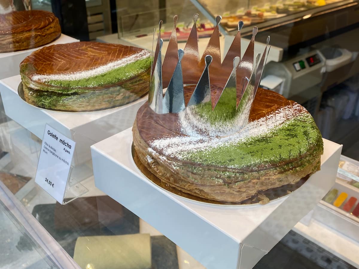 toasted and glazed galette decorated with matcha green powder and a silver crown