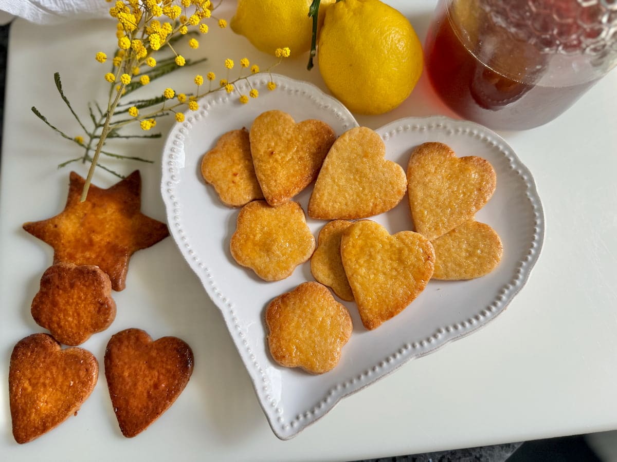 plate of golden honey glazed cookies next to well baked ones after only a few more minutes