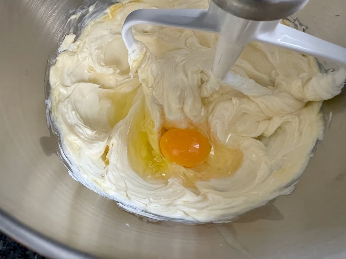 beating cream cheese, sugar, cream and egg in a mixer with a paddle beater