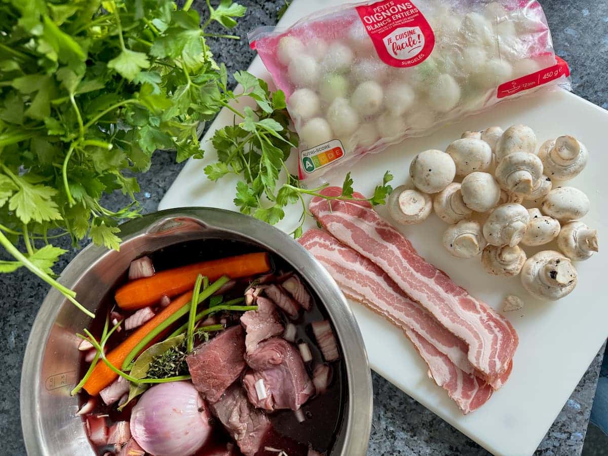 Beef stew red wine marinade with garnish ingredients of pearl onions, mushrooms and bacon