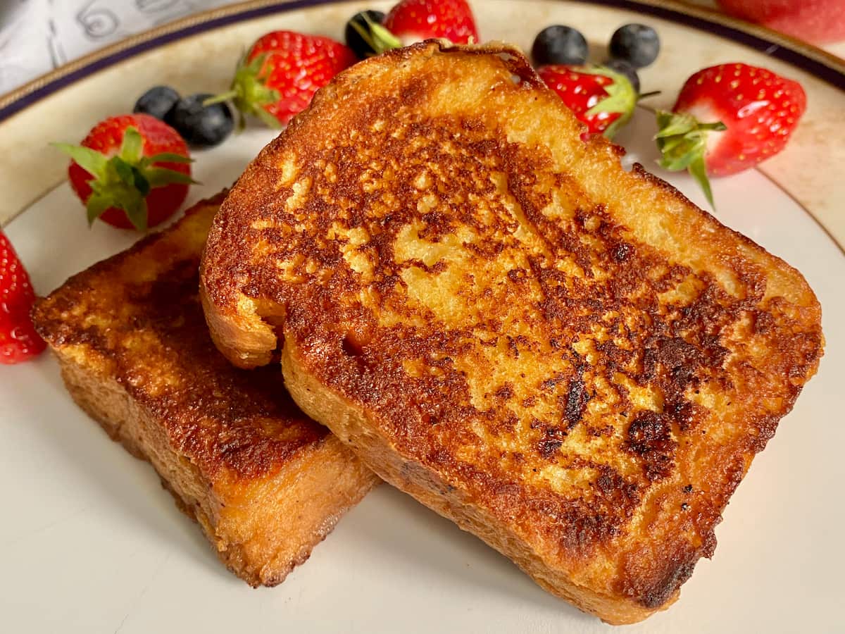 slices of French toast decorated with strawberries and blueberries