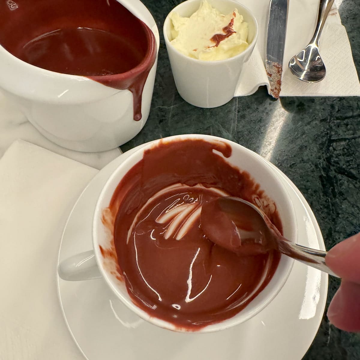 scraping the bottom of a thick hot chocolate in a cup