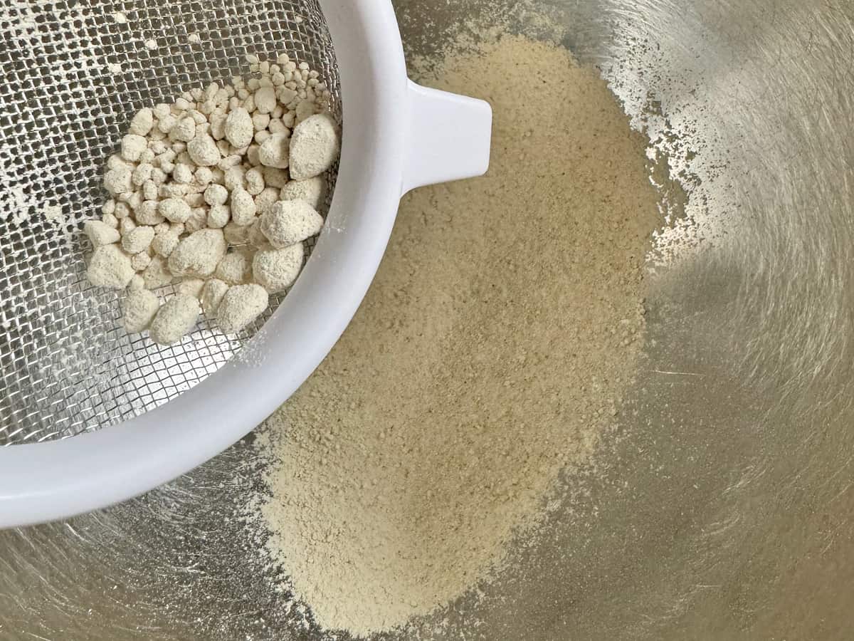 sifting out lumps of chestnut flour through a sieve