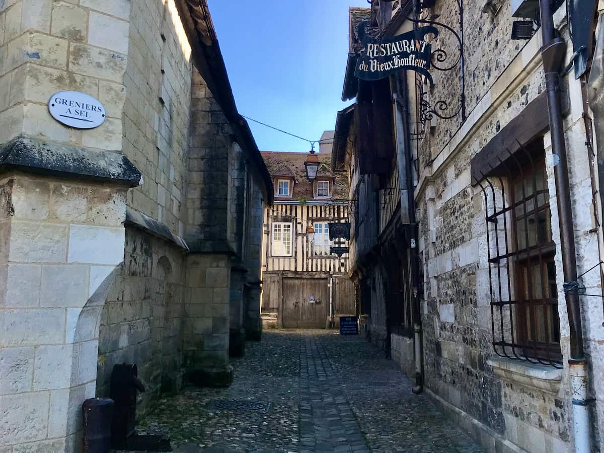 old cobbled French street with a historic restaurant in Honfleur