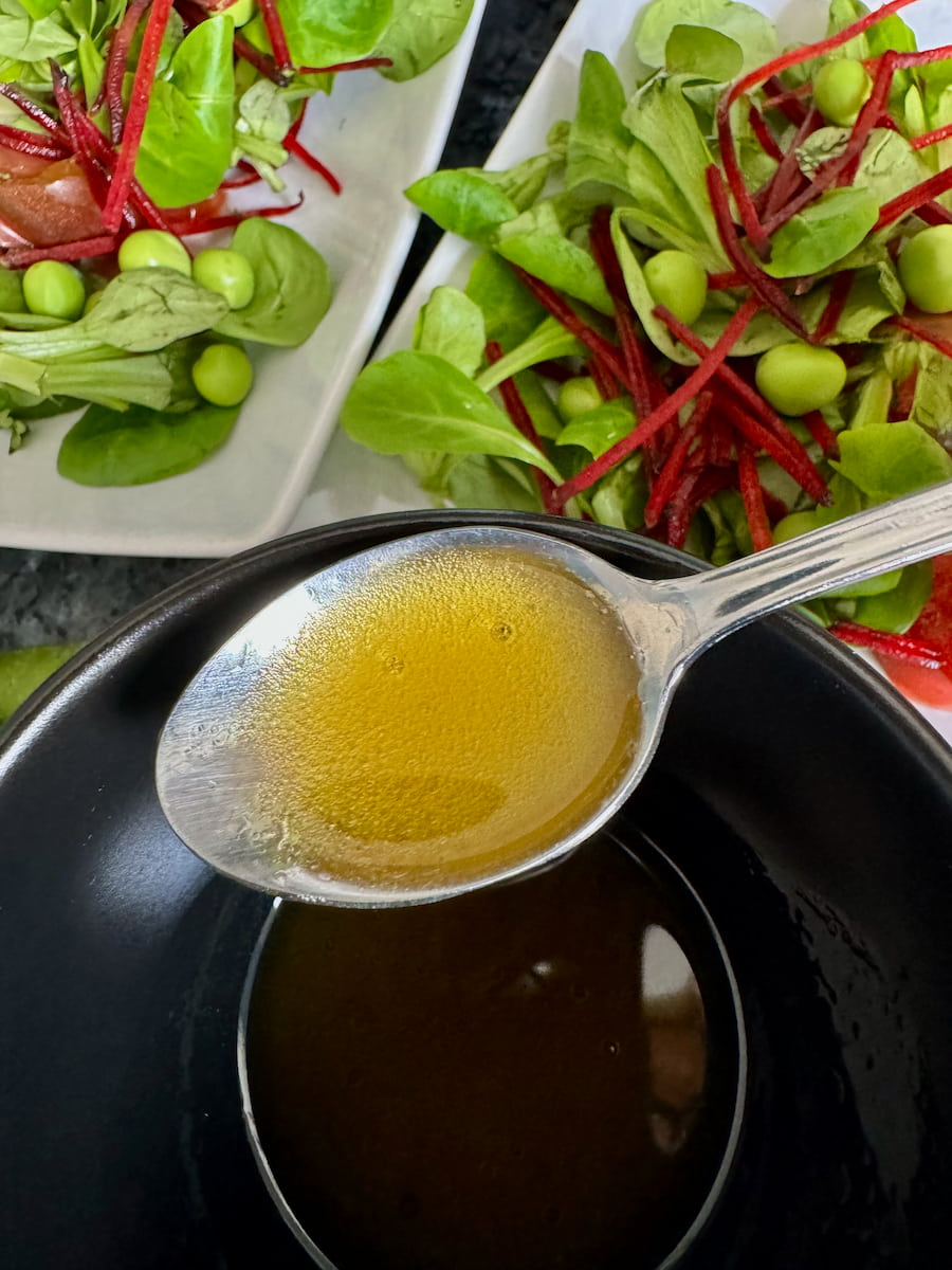 spoon of mixed vinegar and oil to create a French vinaigrette