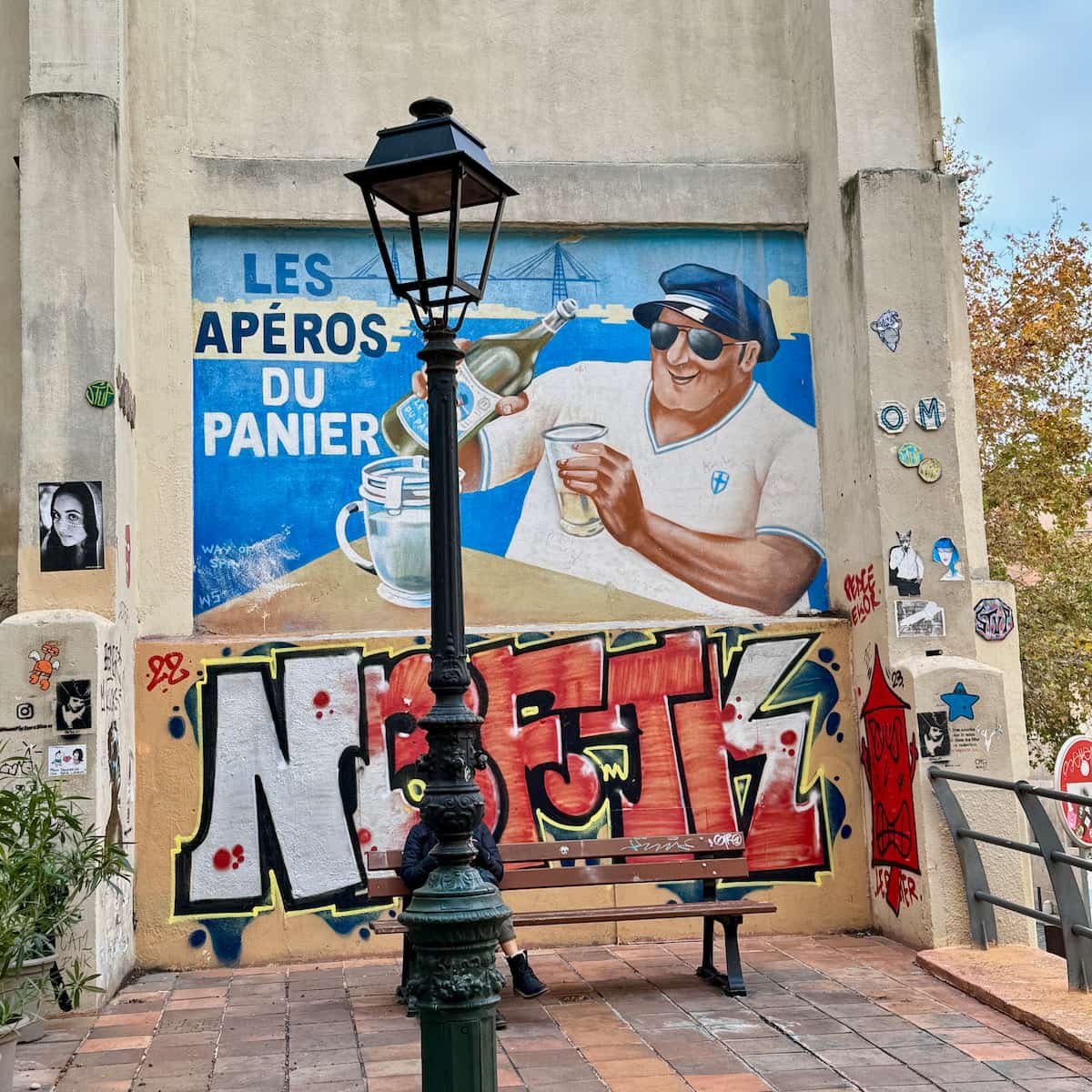 street art of a Marseillais drinking Pastis as an aperitif