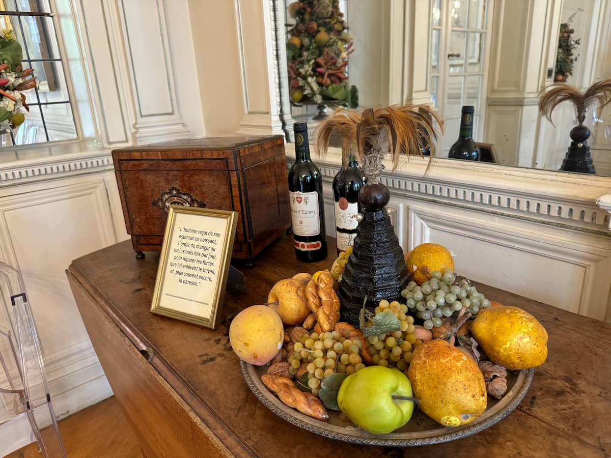 fruit platter with wine bottles and citations from Dumas Great Dictionary of Cuisine