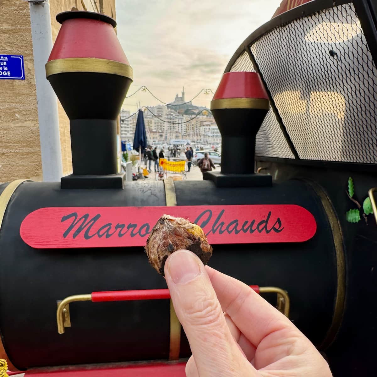 roasted chestnuts from a French train in Marseille with the Basilica in the background