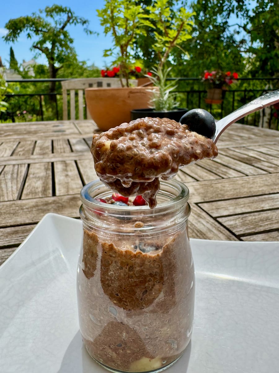 spoonful of perfectly thickened chocolate chia pudding after the seeds have soaked in coconut milk overnight
