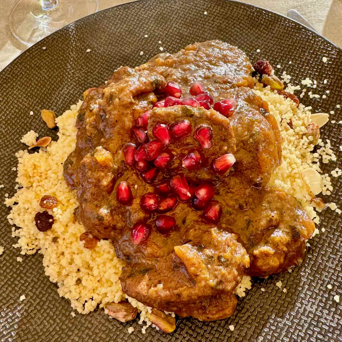 chicken tagine with apricots served with semolina couscous and pomegranate seeds