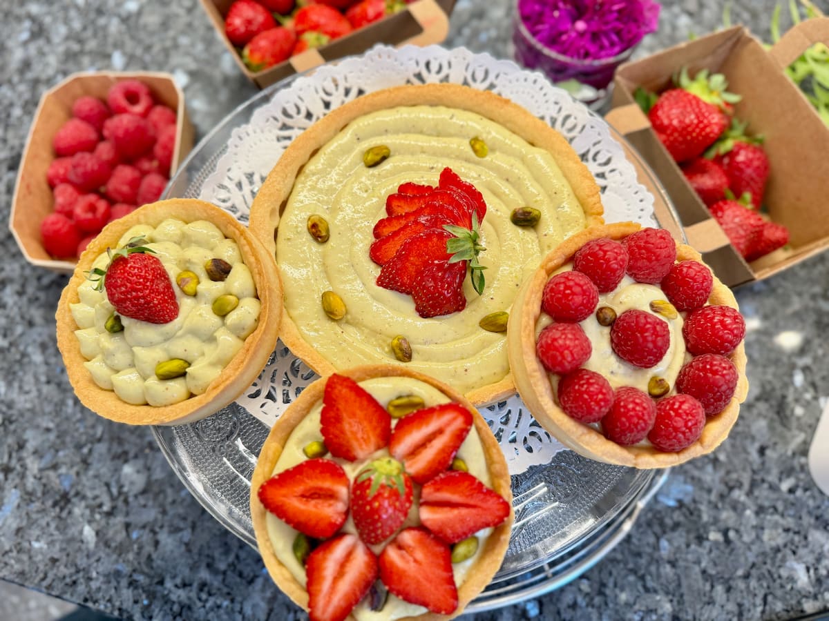 pistachio tarts and tartlets topped with strawberries and raspberries