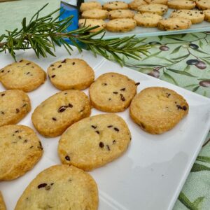 thin French sablé biscuits with cheese and seeds on plates for an aperitif
